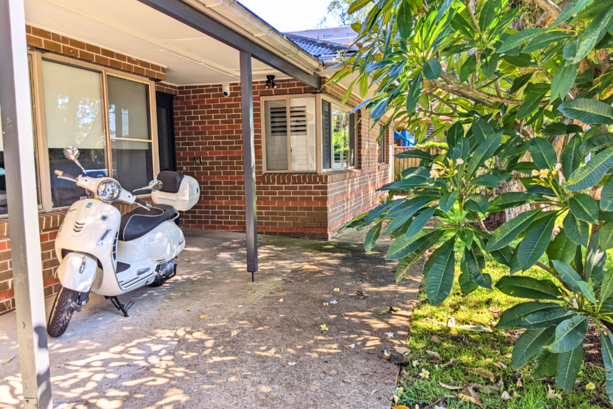 outside the casa mia house, where a scooter is parked out the front